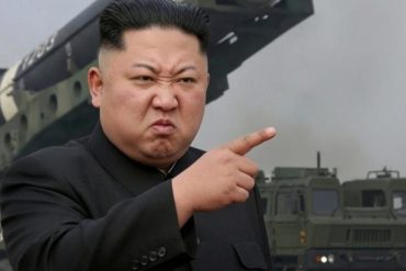 Military leader pointing at camera in front of weapons displays clickbait propaganda image
