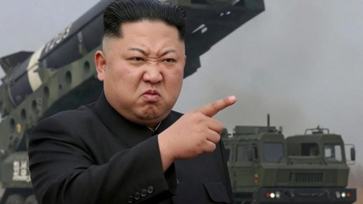 Military leader pointing at camera in front of weapons displays clickbait propaganda image