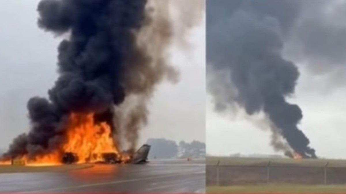 Dramatic plane crash scene showing aircraft wreckage engulfed in flames and heavy black smoke on runway