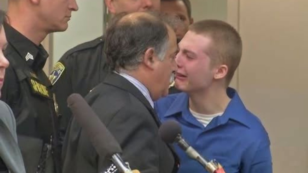 Teen sentenced 452 years stands with military officials and legal representatives during courthouse proceeding