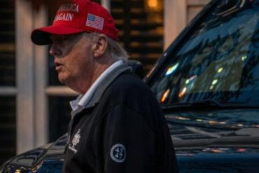 Trump late-night sighting shows former president in red cap and dark jacket near vehicle