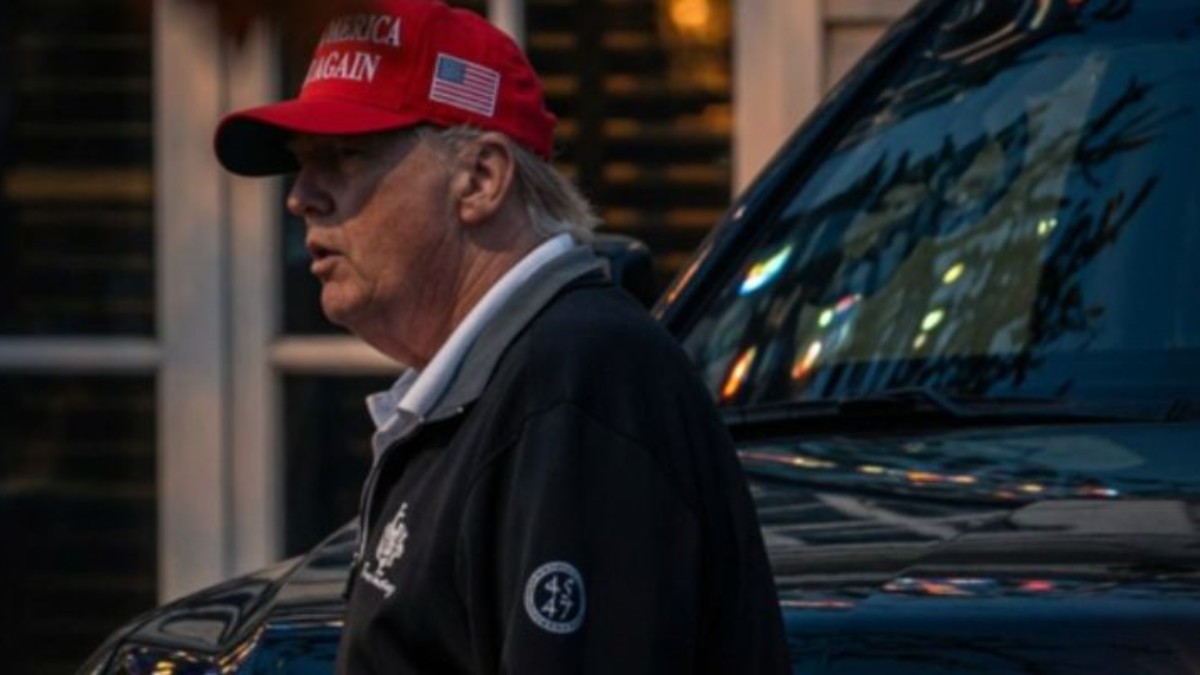 Trump late-night sighting shows former president in red cap and dark jacket near vehicle