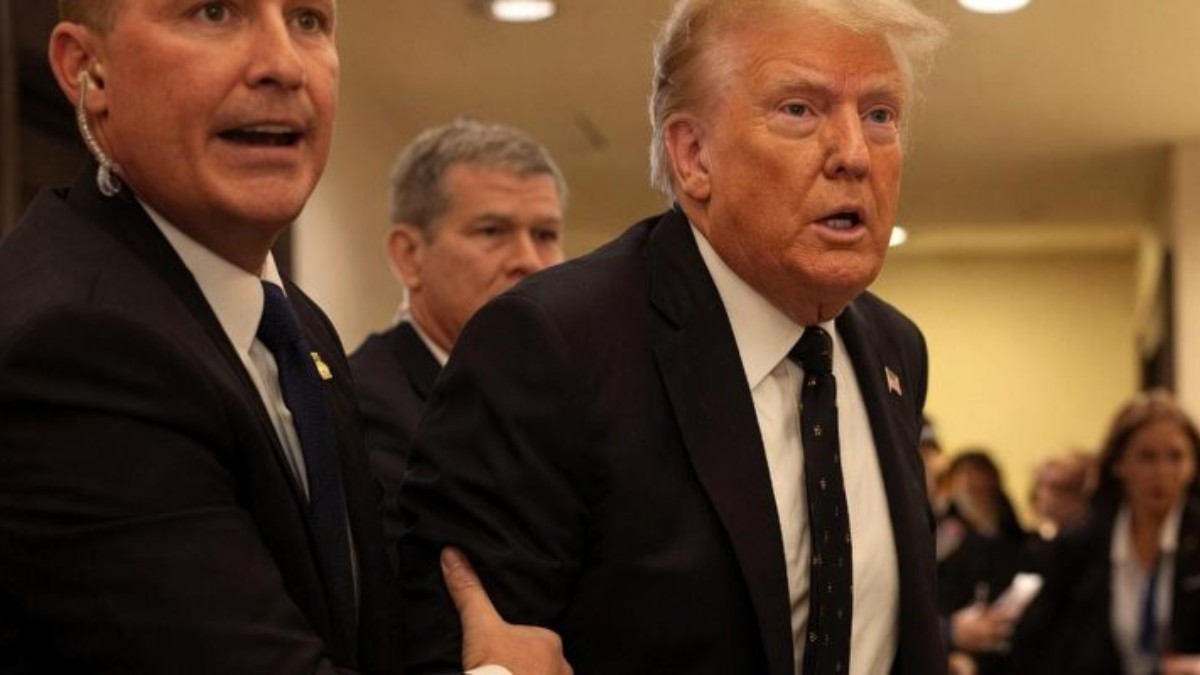 Trump shooting White House Correspondents dinner event with security personnel in formal attire